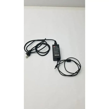 Black plastic mean well gs60a24-p1j power supply adapter with coiled black cables and standard plug for electronic devices