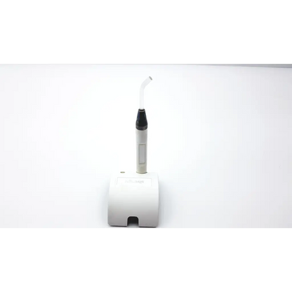 White dental handpiece with black tip and curved transparent nozzle on its matching white silverlight charger ad2-49 base