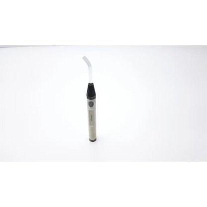 A sleek translucent gray handheld oral irrigator with black grip and curved white nozzle in mectron 305030862 silverlight charger ad2-49