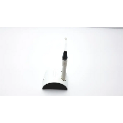 White and black dental handpiece with transparent tip on matching silverlight charger ad2-49 stand