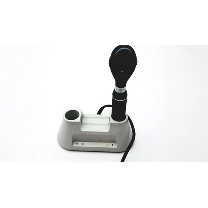 Black medline riester otoscope with sleek ergonomic design resting in gray charging base of diagnostic desk set
