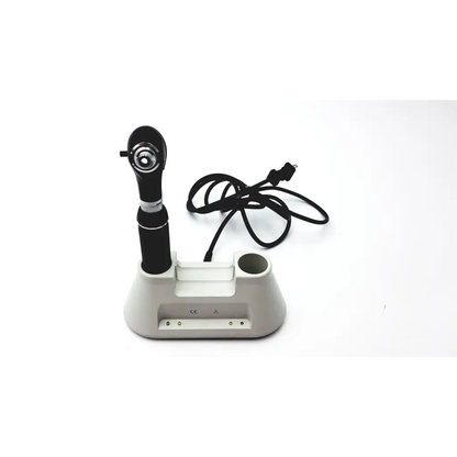 Black medline riester otoscope with silver accent resting on white charging base of ophthalmoscope diagnostic desk set