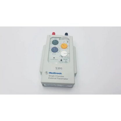 Medtronic 5391 single chamber external pacemaker with gray plastic housing and blue and yellow color-coded dials