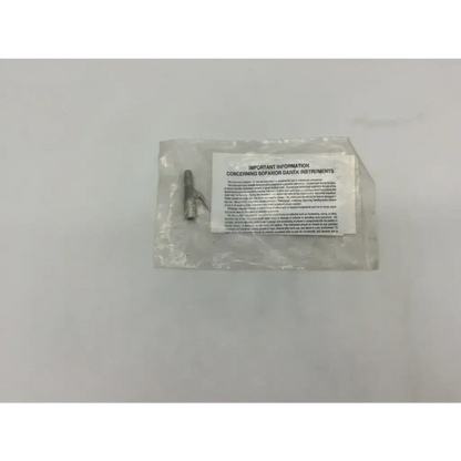 A clear plastic bag containing a metallic screw and white label for medtronic 825-200 provisional clamp surgical stainless