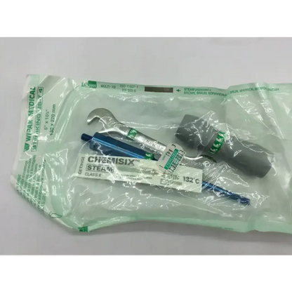 A sterile green-wrapped medtronic misonix sonicone plus ultrasonic wound care kit with silver wrench and blue-handled tools