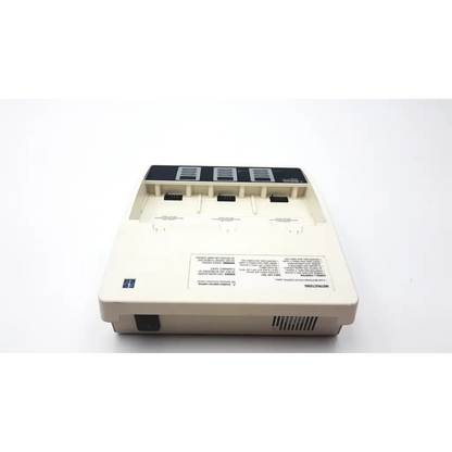 Cream-colored plastic medtronic physio-control battery support system charger with three slots and black top panel