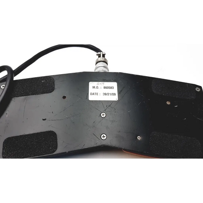 Black plastic keyboard base with silver connector and label on the back of megadyne aquiline 971-swnom bipolar footswitch