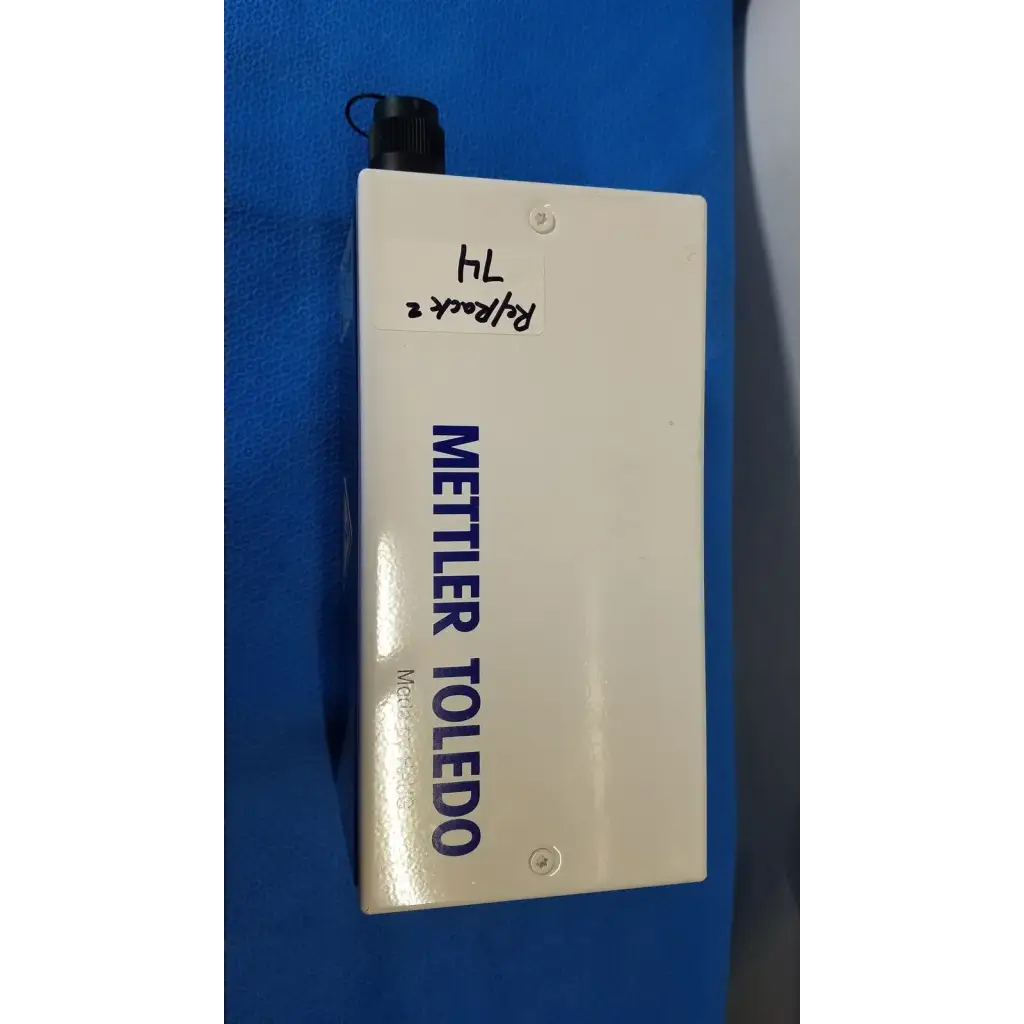 White rectangular mettler toledo haug slc power supply with black threaded cap and blue lettering for industrial use