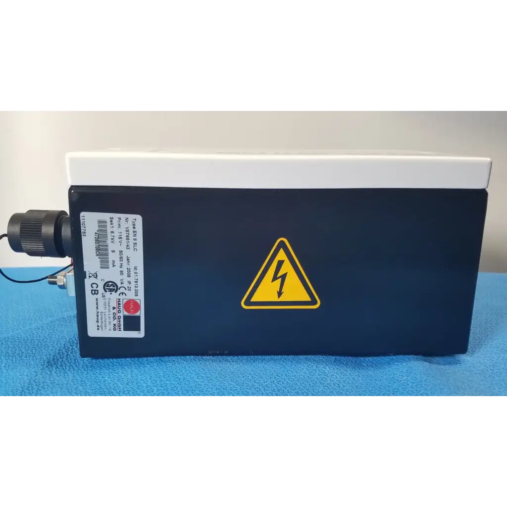 Black rectangular mettler toledo haug slc power supply with white top and yellow lightning bolt warning symbol from hannover