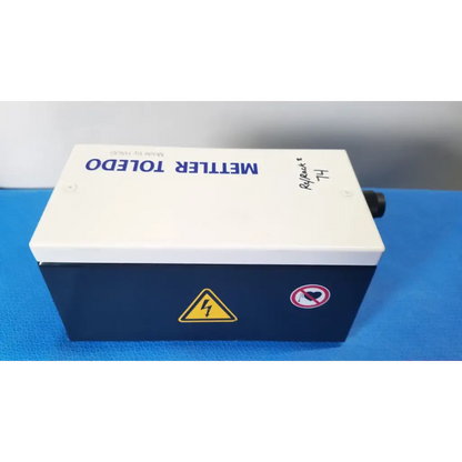 White and navy blue mettler toledo haug slc power supply box with yellow warning symbol and no heart sticker on side