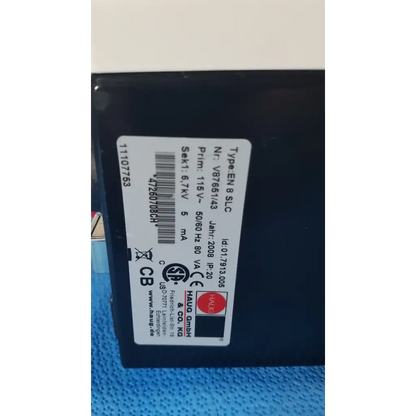 Black rectangular mettler toledo haug slc power supply with white label showing technical specifications on the back side