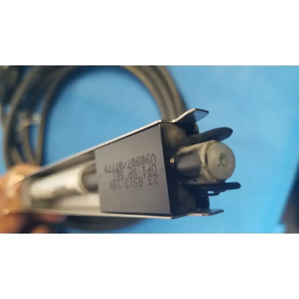 Silver rectangular metal housing with black plastic parts and coiled cable showing engraved serial numbers on mettler toledo haug static eliminator power supply back side