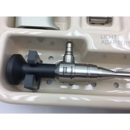 Silver and black metallic smartrelease ectr carpal handpiece labeled autolase resting in off-white tray for carpal tunnel release