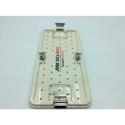 Beige plastic surgical instrument tray with metal clamps and perforated surface for microaire smartrelease ectr carpal use