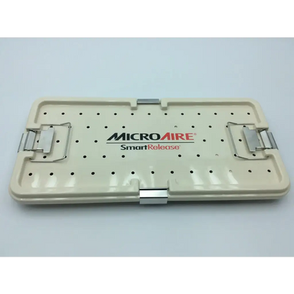 Cream-colored plastic surgical instrument tray with metal latches branded microaire smartrelease for ectr carpal tunnel release