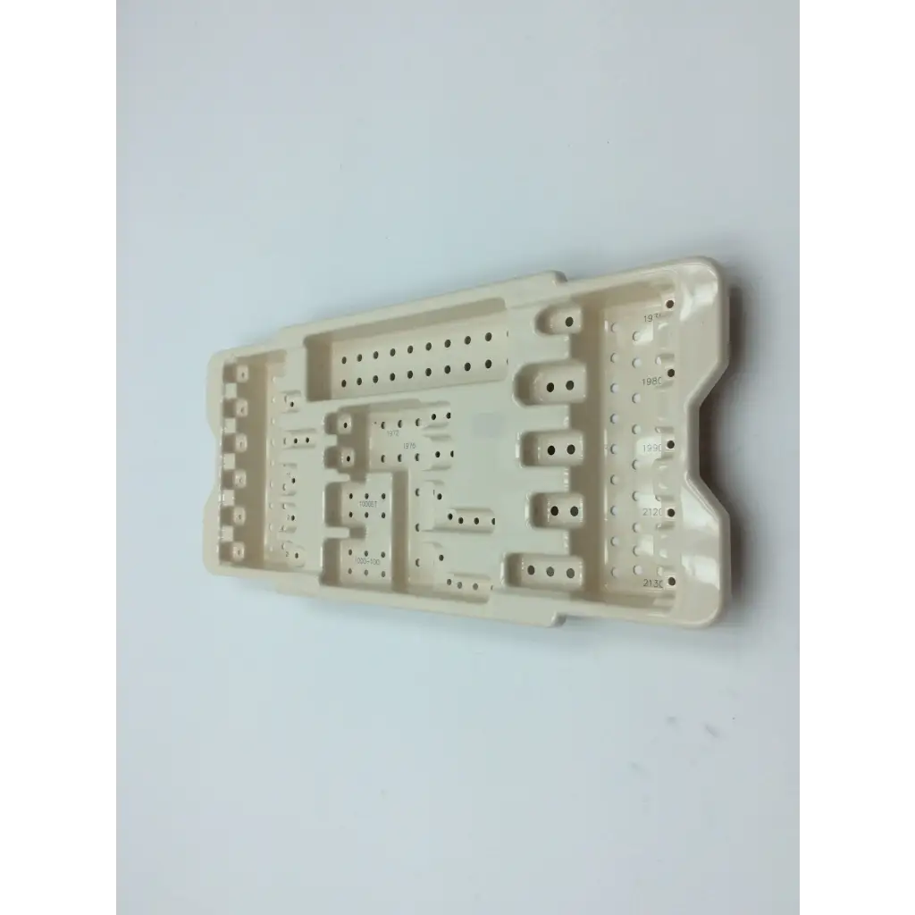 Beige plastic dental surgical tray with compartments and perforated sections for micro aire surgical instruments cases