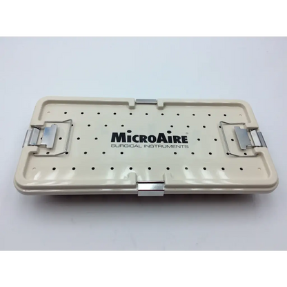 Cream-colored plastic micro aire surgical instrument tray with silver metal latches and perforated surface for sterile storage