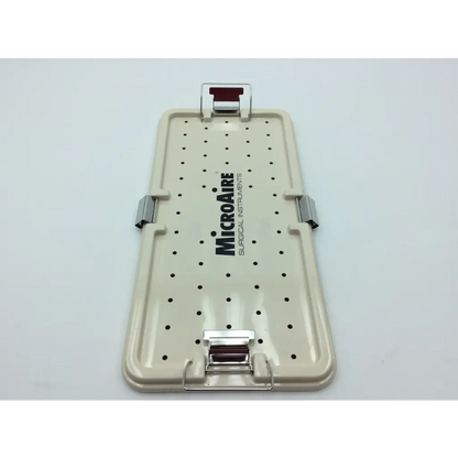 Beige plastic micro aire surgical instrument tray with black perforations and silver metal latches for secure storage