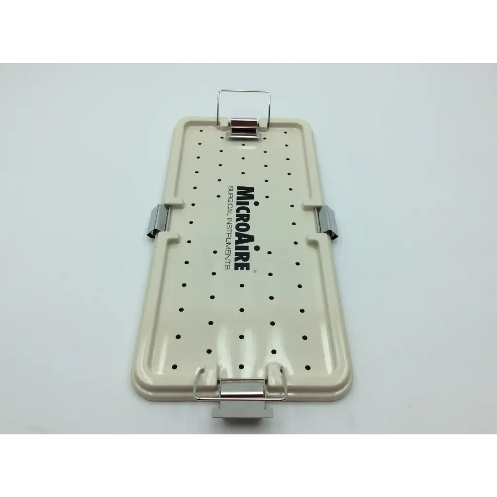 Beige plastic surgical instrument tray with black perforated dots and silver latches from micro aire surgical instruments