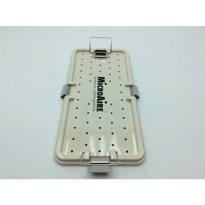 Beige plastic surgical instrument tray with black perforated dots and silver latches from micro aire surgical instruments