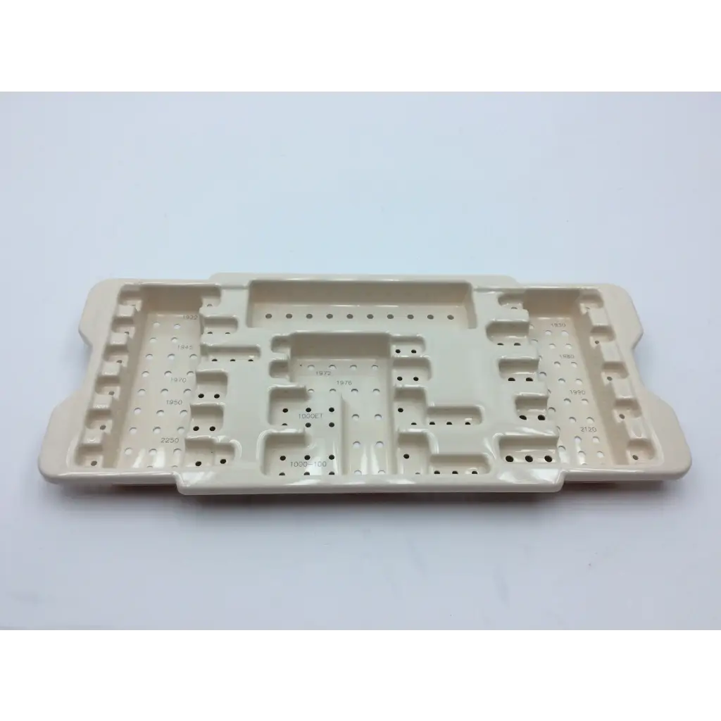 Beige ceramic surgical tray with compartments and perforations for micro aire surgical instruments with 2x cases