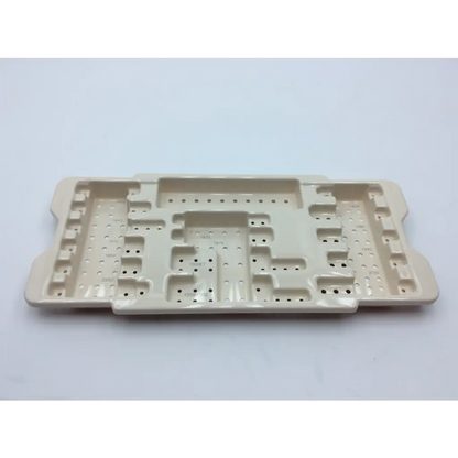 Beige ceramic surgical tray with compartments and perforations for micro aire surgical instruments with 2x cases