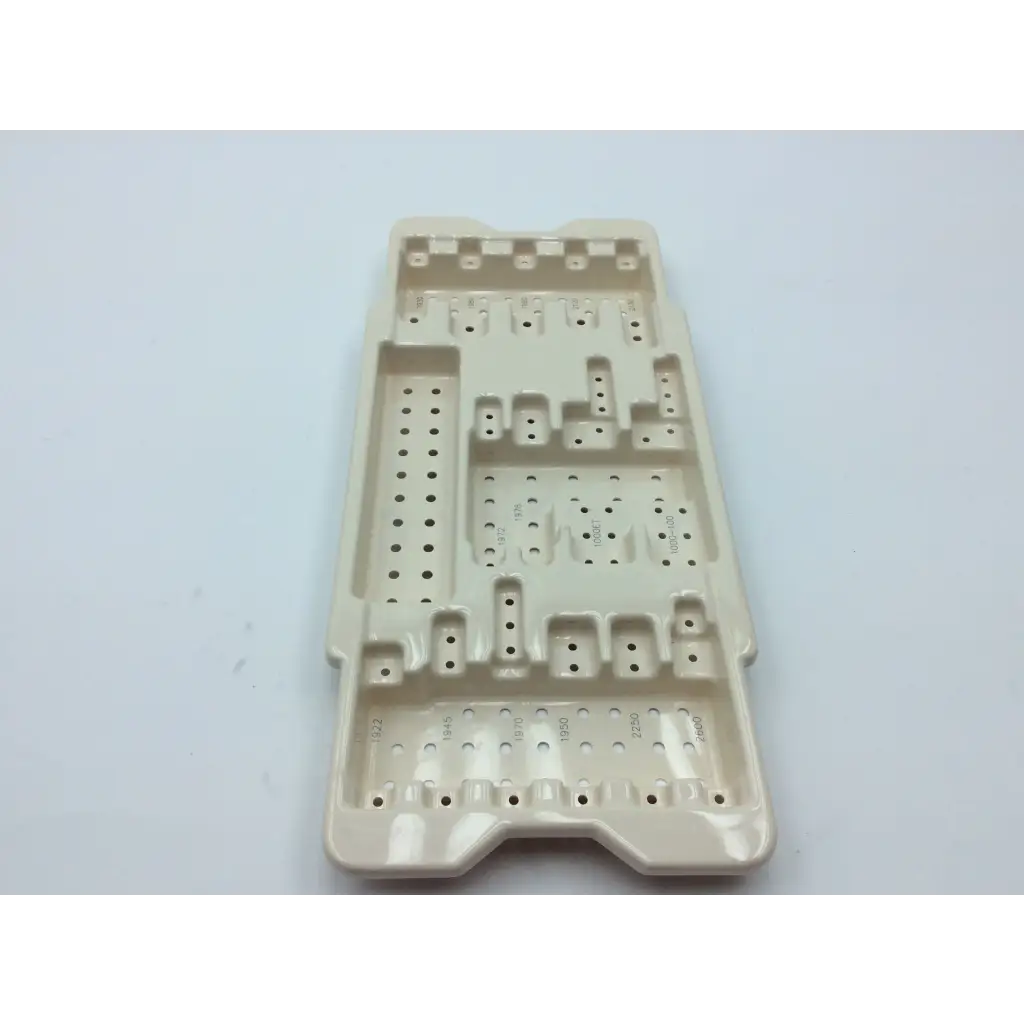 Beige plastic surgical tray with molded compartments and perforations for micro aire surgical instruments cases