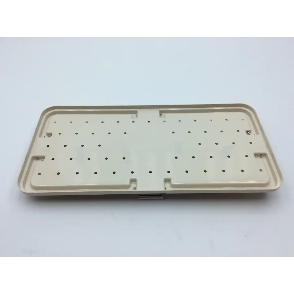 Beige plastic tray with grid holes and raised edges for micro aire surgical instruments with 2x cases