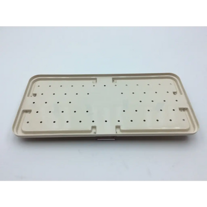 Beige plastic tray with grid holes and raised edges for micro aire surgical instruments with 2x cases