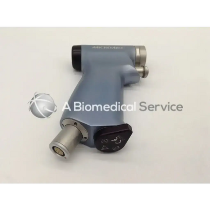 Gray ergonomic microaire 1641 smartdriver handpiece with metallic connectors and black control dial for surgical use