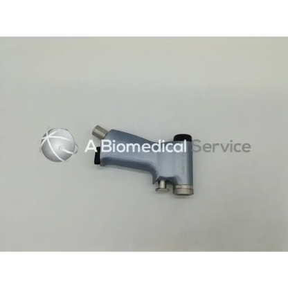 Gray ergonomic air-powered smartdriver handpiece with metallic accents and black trigger for precise surgical use