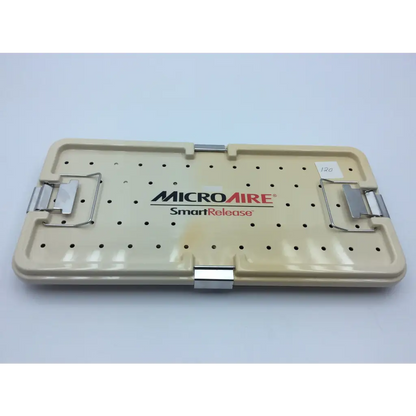 Beige plastic surgical instrument tray with silver metal latches and perforated surface for smart release carpal tunnel