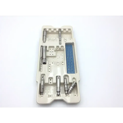 Beige plastic sterilization tray holding silver microaire surgical instruments with a blue microaire ref component
