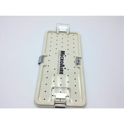 Beige plastic microaire surgical instrument case with black dot pattern silver clasps and sterilization tray