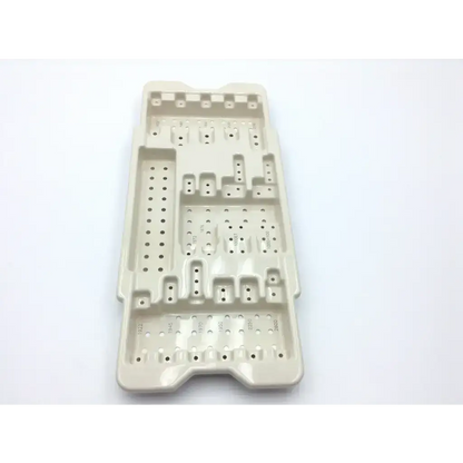 Beige plastic microaire surgical sterilization tray with multiple compartments and perforations for instrument storage