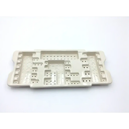 Beige plastic microaire surgical sterilization tray with multiple compartments and perforated sections for instrument storage
