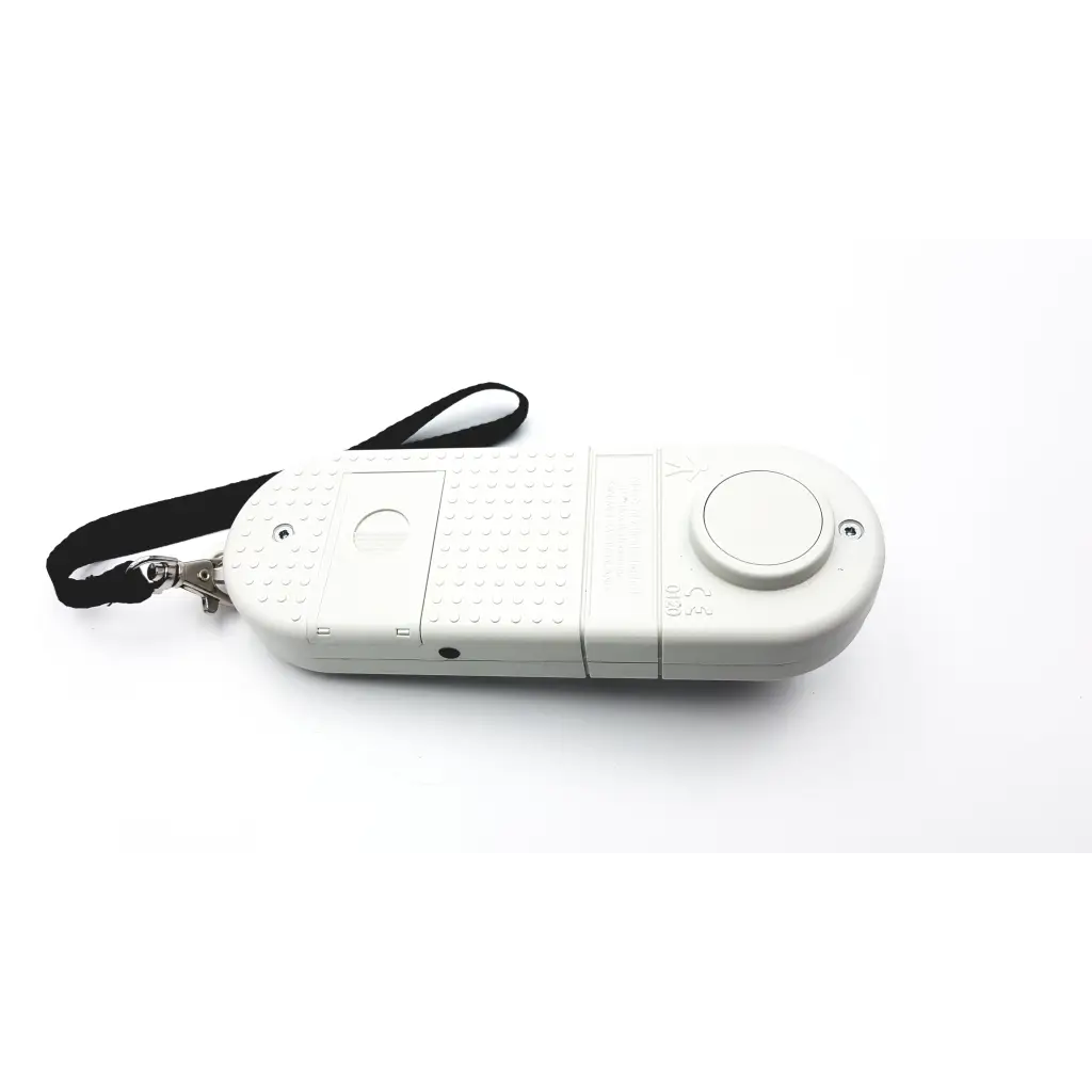 White plastic remote control with textured grip and black wrist strap for microrpm respiratory muscle testing device