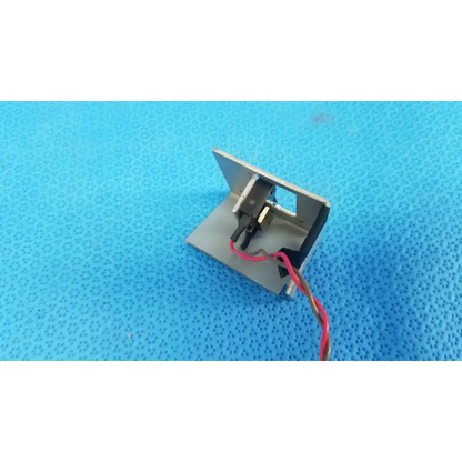Silver metallic electromagnetic lock with red and black wiring for microswitch limit sensor bracket assembly on retinal camera