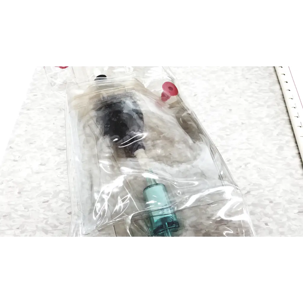 Clear plastic bag containing a black and teal mie personal aerosol monitor with red caps for industrial hygiene use