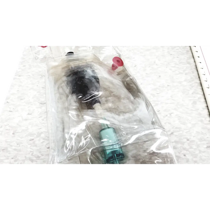 Clear plastic bag containing a black and teal mie personal aerosol monitor with red caps for industrial hygiene use