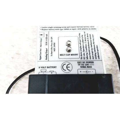 Backside of black plastic belt clip mount with silver screws and battery label for mie personal aerosol monitor industrial hygiene
