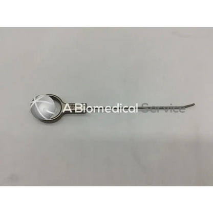 Silver mitek surgical rapidlok pusher with a curved slender metal shaft and circular head engraved with a cross pattern