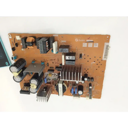 Orange circuit board with black capacitors and silver heat sinks in mitsubishi 934c2280 power supply unit