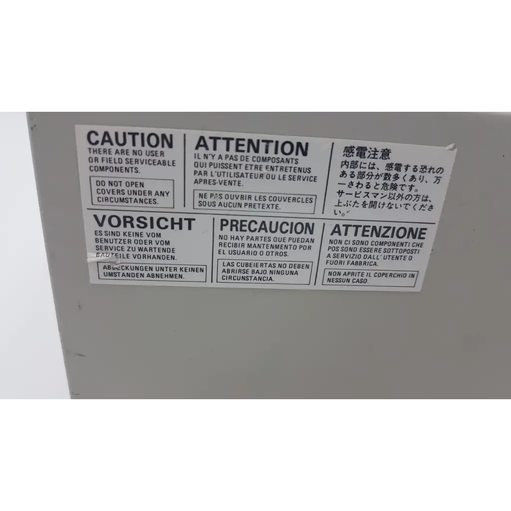 White rectangular warning label with multilingual caution text on mitsubishi cp900um analog color video printer