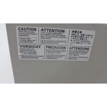 White rectangular warning label with multilingual caution text on mitsubishi cp900um analog color video printer