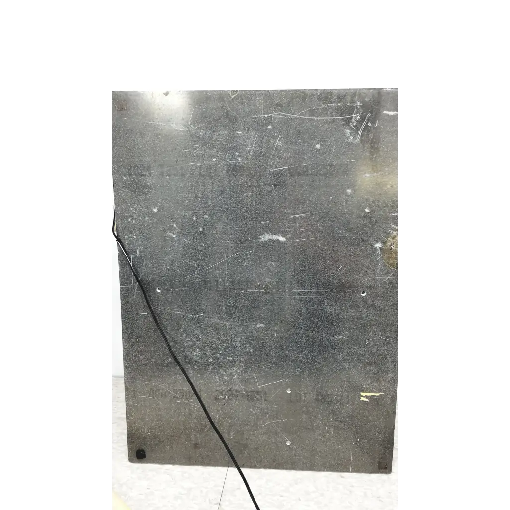 Scratched dark gray metal panel on the back side of mmr technologies vacuum control manifold system with granville-phillips gauge