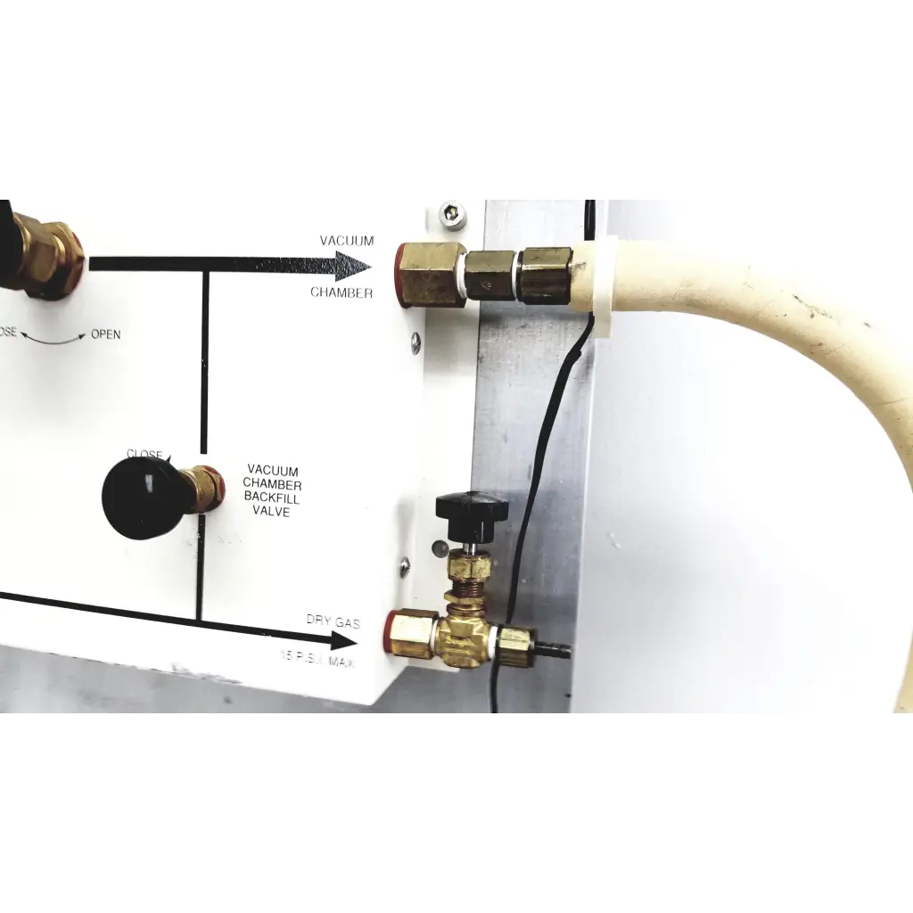 Brass valve with black handle labeled vacuum chamber backfill valve on white panel in mmr technologies vacuum control manifold