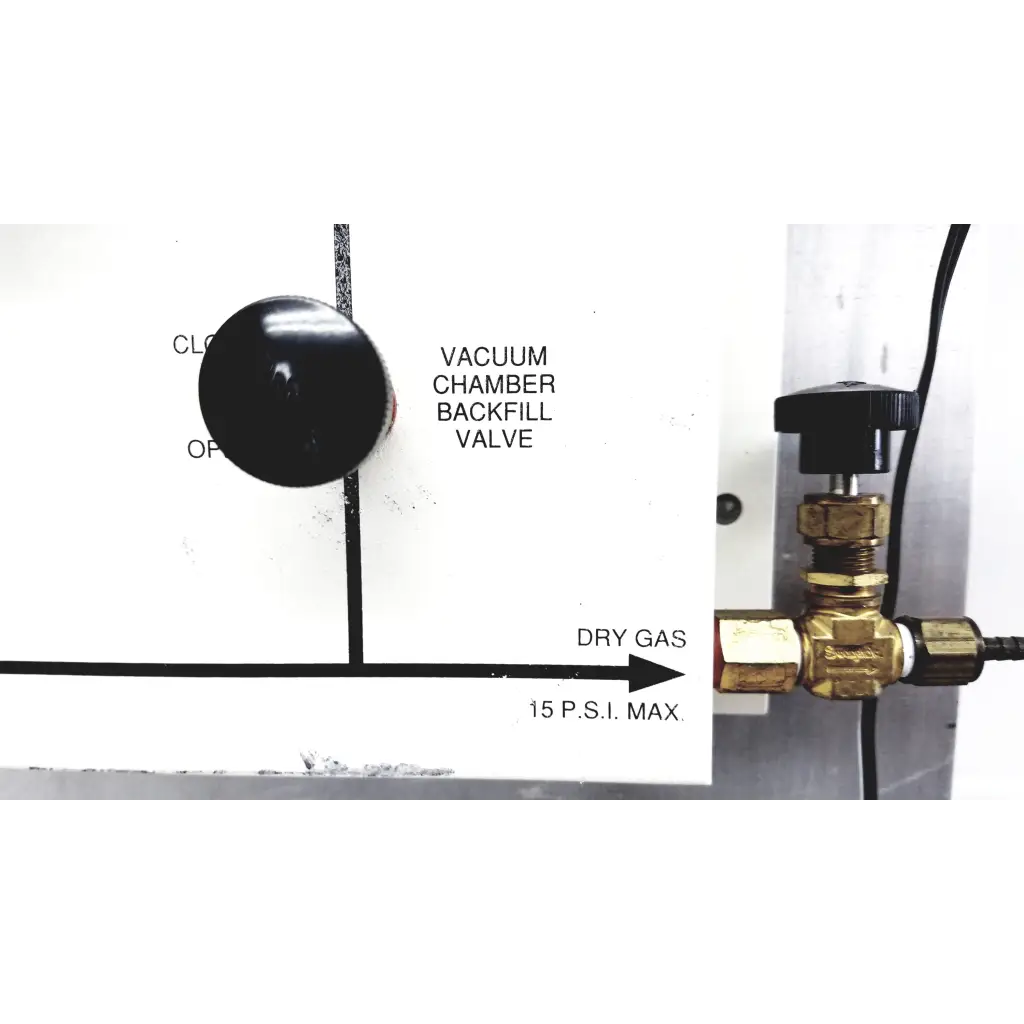 Gold brass vacuum control manifold valve with black knob and threaded connections on mmr technologies system panel