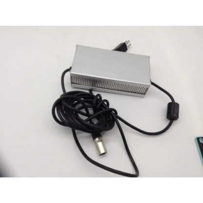 Silver rectangular 24v scooter wheelchair battery charger with perforated side panel and black coiled cable metal connector