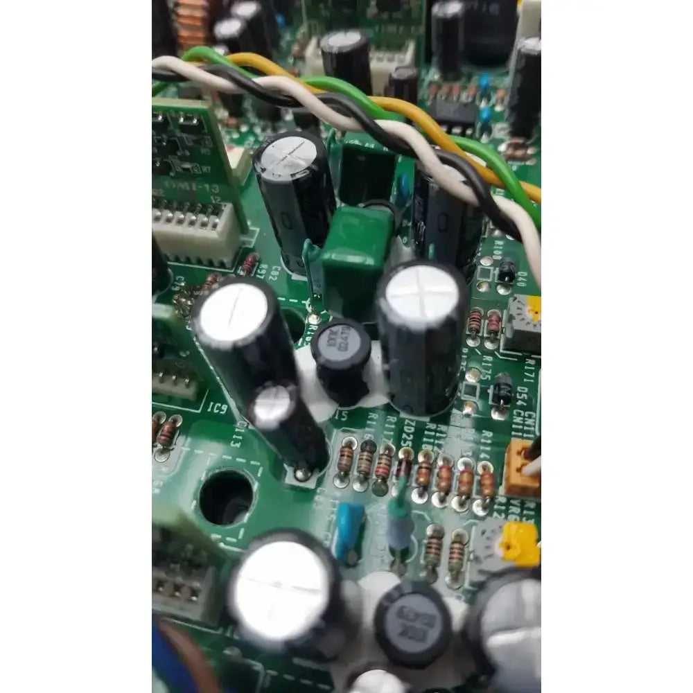 Black cylindrical capacitors with silver tops on a green circuit board of nayuta nb497 power supply control board